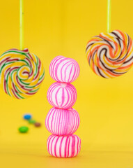Fototapeta na wymiar Colorful lollipop candies isolated on yellow background
