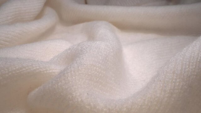 The texture of a white soft warm cozy woolen knitted sweater