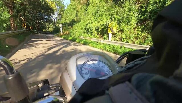 Someone riding motorbike on nature sunlight mountain view with many the curve road in thailand.