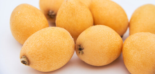 Ripe loquat on a white background