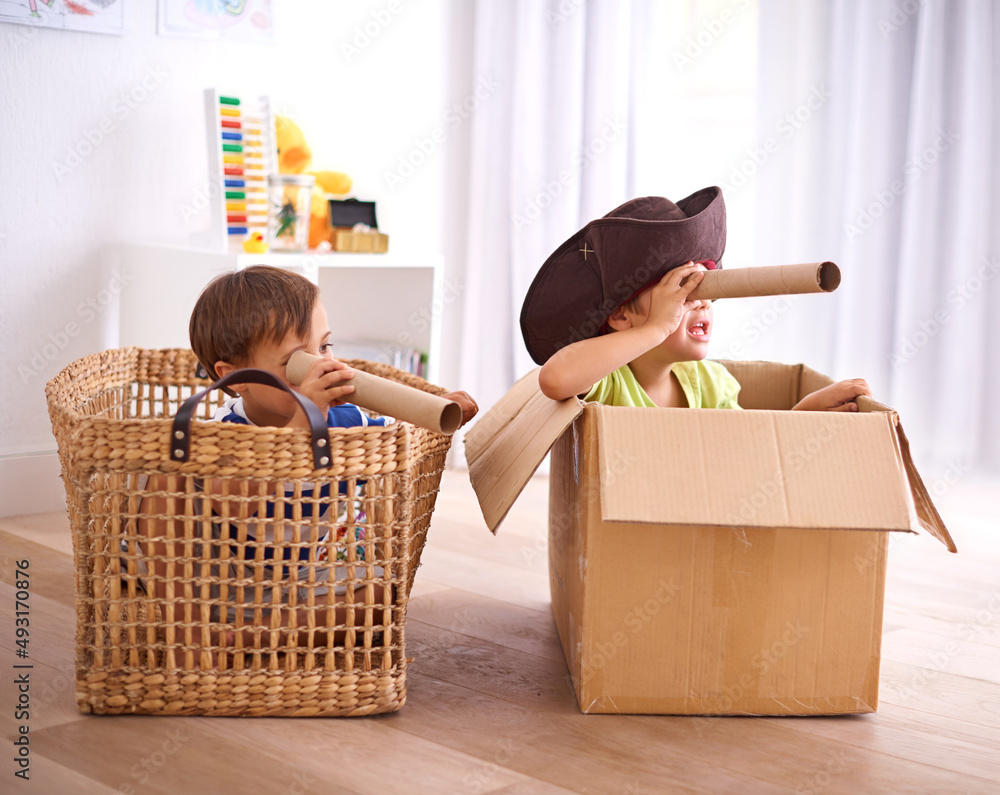 Sticker Pirates at play. Shot of two young boys playing make believe as pirates.