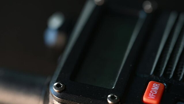 macro slide over a non-active HAM radio handheld, walkie talkie style device