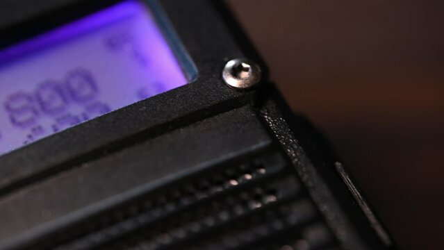 macro slider over a handheld HAM radio transceiver that lights up as it received communication