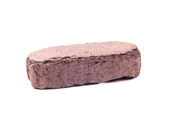 white background. the briquette is dark in color. an alternative type of fuel for heating. close-up.