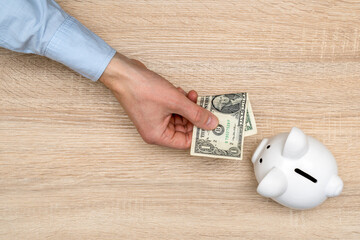 Hand Giving One Dollar Bill For Piggy Bank