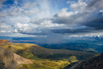 Majestic mountain landscape opening from a viewing point. Panorama of mountain peaks and stormy sky.