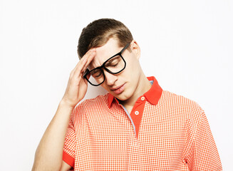 Young handsome man with hand on head for pain in head because stress.