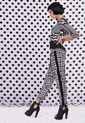 Polka dot style. Studio shot of a retro-stylish young woman against a black and white polka dot...