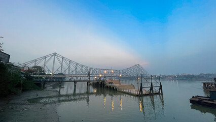 Howrah bridge on the river Hooghly with the blue sky. The cantilever bridge is considered the busiest bridge in India.