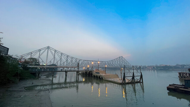 Howrah bridge on the river Hooghly with the blue sky. The cantilever bridge is considered the busiest bridge in India.