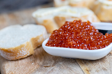 red salmon or trout caviar with white baguette and butter