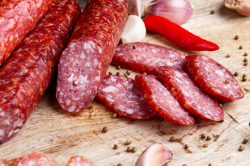 sliced pieces of sausage from meat are lying on a cutting board