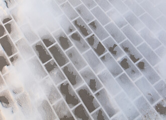 Paving slabs in the snow in winter.