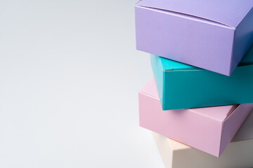 Pile of colorful cardboard boxes on white background