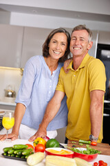Healthy is the way to go. Portrait of a loving mature couple standing beside each other in the kitchen.