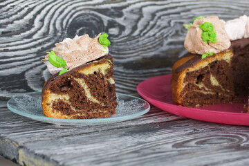 Marble cake with chocolate and marshmallow roses. Cut into pieces. Close-up.