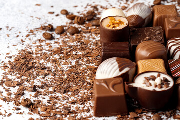Chocolate candies and chocolate pieces pile for background