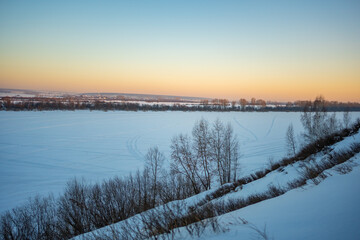 Winter orange sunset in forest over river Tom near Kemerovo, Siberia, Russia