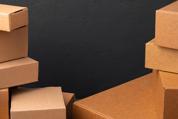 Stack of cardboard boxes against black background