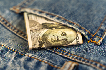One hundred dollars in jeans pocket close up. 