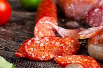 sliced pieces of sausage from meat are lying on a cutting board