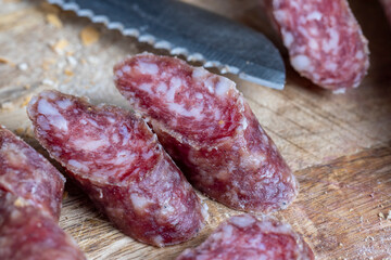 sliced pieces of sausage from meat are lying on a cutting board