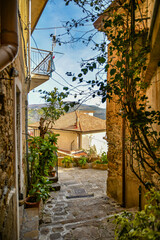 A narrow street among the old stone houses of Castellabate, town in Salerno province, Italy.	