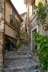 Fototapeta na wymiar A narrow street among the old stone houses of Castellabate, town in Salerno province, Italy.