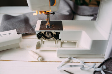 Sewing machine, accessories and fabric. Cozy creative sewing process at home