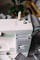 Sewing machine, accessories and fabric. Cozy creative sewing process at home