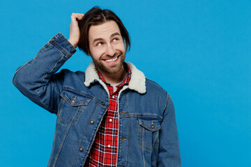 Pensive puzzled fun young brunet bearded man 20s wear warm denim jacket look aside scratches at...