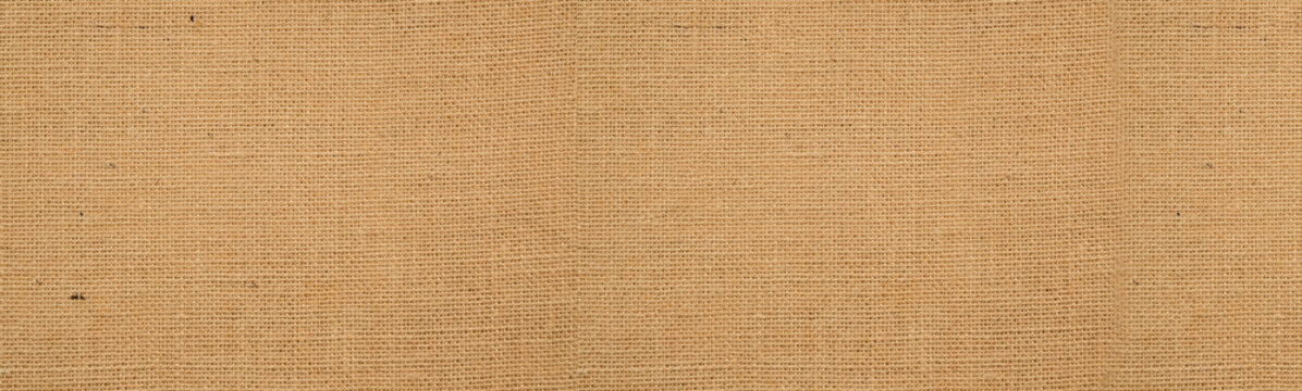 Cotton woven fabric background with flecks of varying colors of beige and brown. with copy space. office desk concept, Hessian sackcloth burlap woven texture background High Resolution ,panoramic