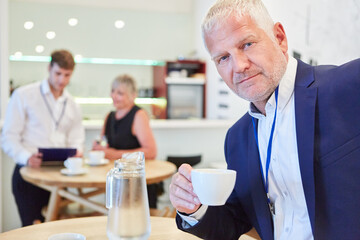 Businessman drinking coffee in the canteen