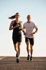 Its all about endurance. Full length shot of two young runners training outdoors.