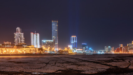 Early Spring night on the banks of the pond in the city center