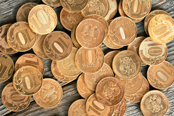 ruble coins on a wooden background, inflation and devaluation in money, anti-Russian sanctions,...