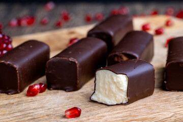 dessert of creamy filling and chocolate on a board