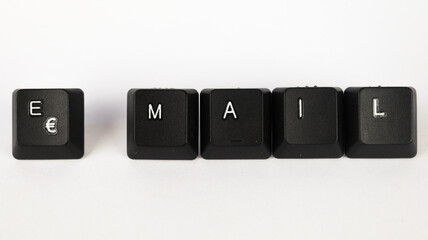 Email text created with keyboard keys isolated on white background, white e-mail letters on black keyboard, top view