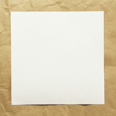 Square white empty sheet of paper on a beige craft paper. Concept of analysis, study, attentive work. Stock photo with empty place for your text and design. Square image shape.