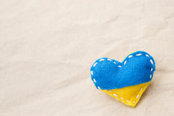 Ukraine flag theme. Heart shape pin badge made of blue and yellow stuffed felt. Topical issues of...