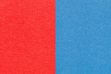 Fototapeta premium Texture of craft red and blue paper background, half two colors, macro. Structure of vintage dense craft cardboard