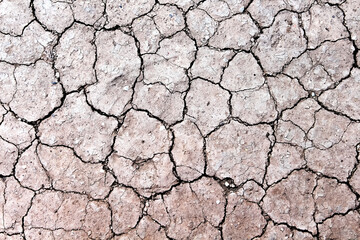 Dry soil with cracked texture arid backgroun top view