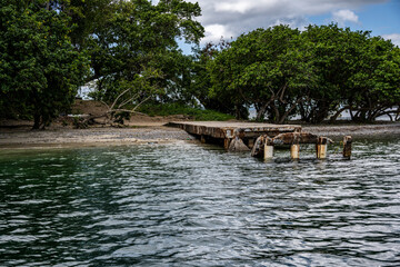 a pier in the sea and a gazebo in a landscape against the background of the sea and blue sky 