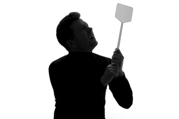 Man in suit holding a fly swatter wanting to kill annoying mosquito