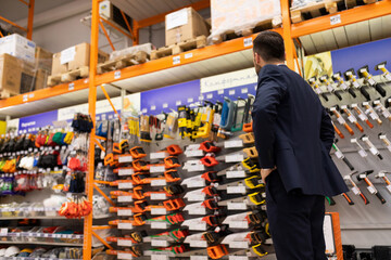 store owner inspecting shop windows in a construction hypermarket