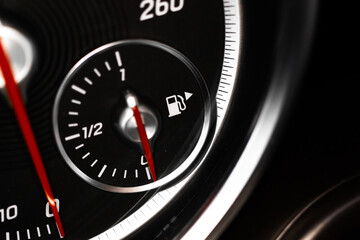 Low fuel gauge showing fuel dashboard, glowing indicator, close-up view