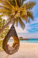 Foto auf Glas Tropical beach sunset as summer landscape with luxury resort beach palm swing hammock, sand seaside shore for sunset beach landscape. Tranquil beach horizon scenery vacation and summer holiday concept © icemanphotos