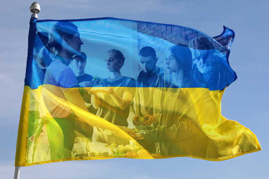 Double exposure of Ukrainian flag outdoors on sunny day and refugees receiving food from volunteers. Help during war