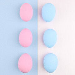 Pink eggs are laid out in a row on a blue background, and blue eggs are laid out on a pink background. Opposite. Geometric Easter background.