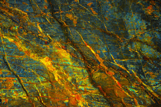 Yellow orange blue abstract grunge background. Toned rock surface texture. Close-up. Colorful stone background for design.